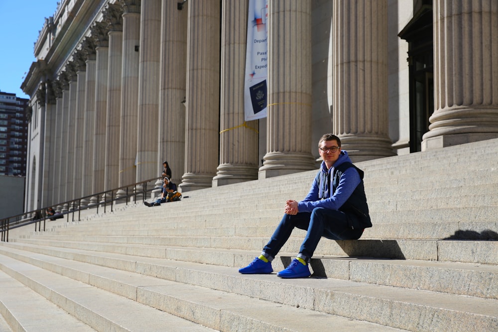 a man sitting on the steps of a building