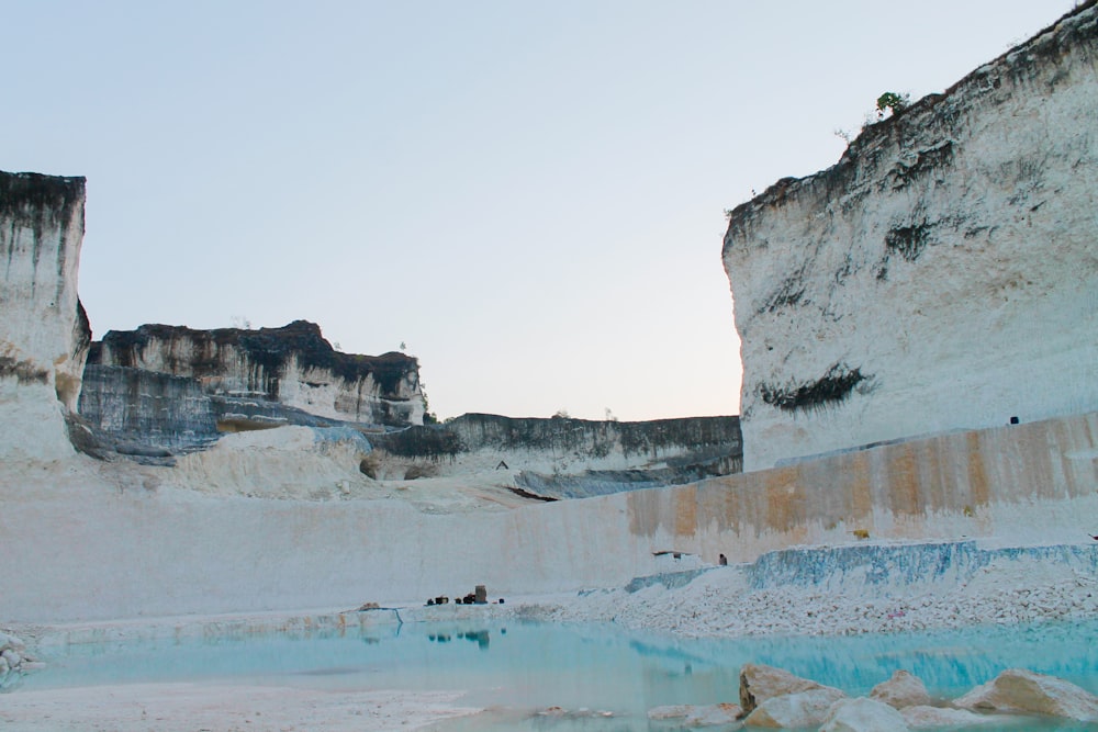 a group of people standing on top of a blue and white mountain