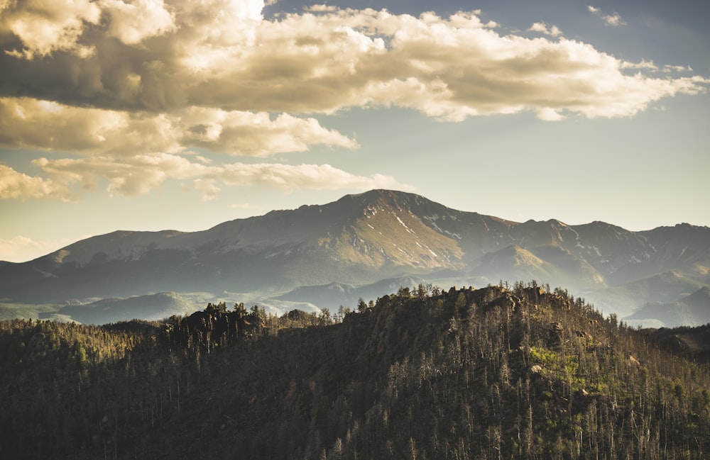 a view of a mountain range with clouds in the sky