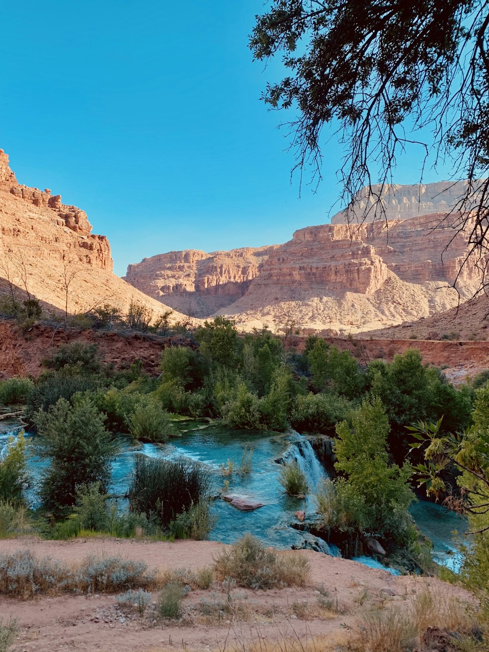 a river running through a canyon surrounded by mountains