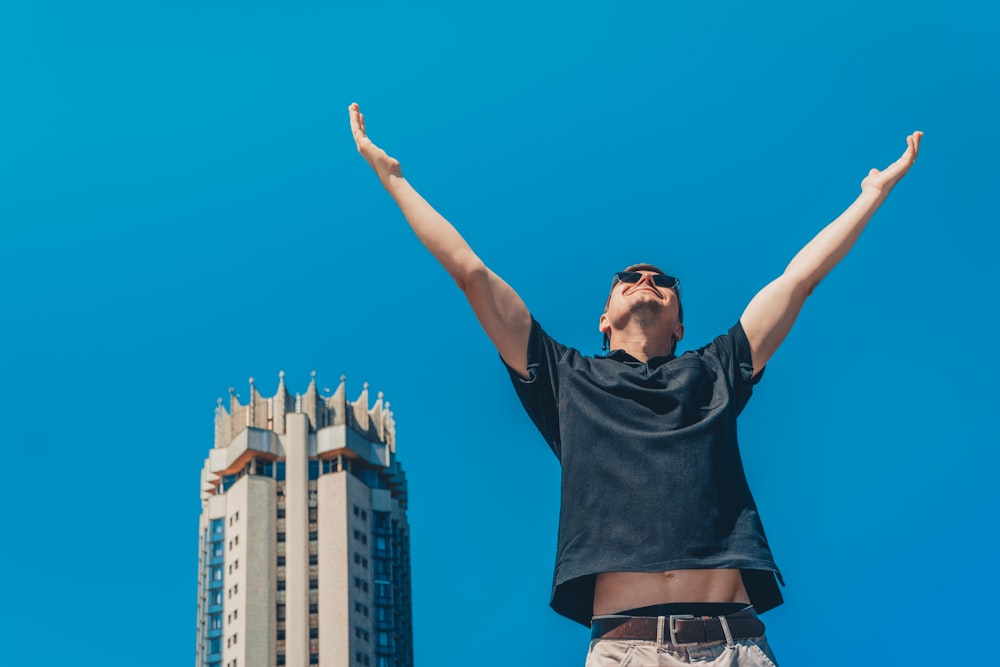 a man standing in front of two tall buildings