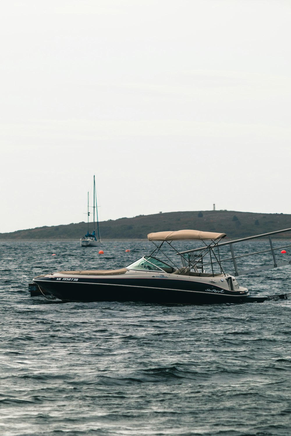 a small boat in the middle of a body of water