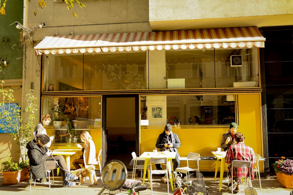 a group of people sitting outside of a building