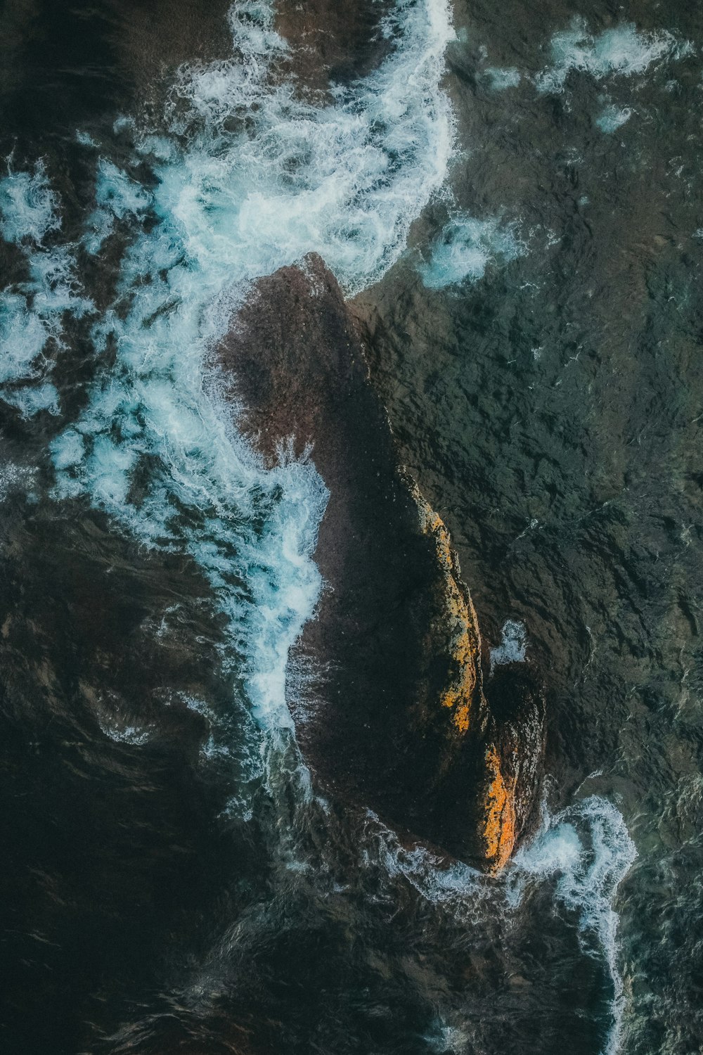 an aerial view of the ocean with waves