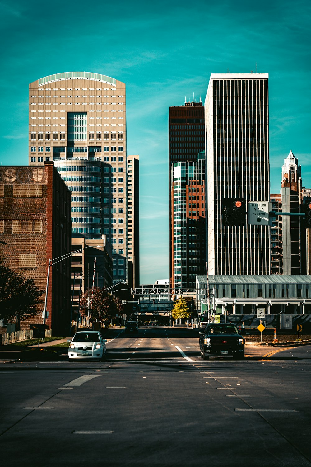 a view of a city street with tall buildings