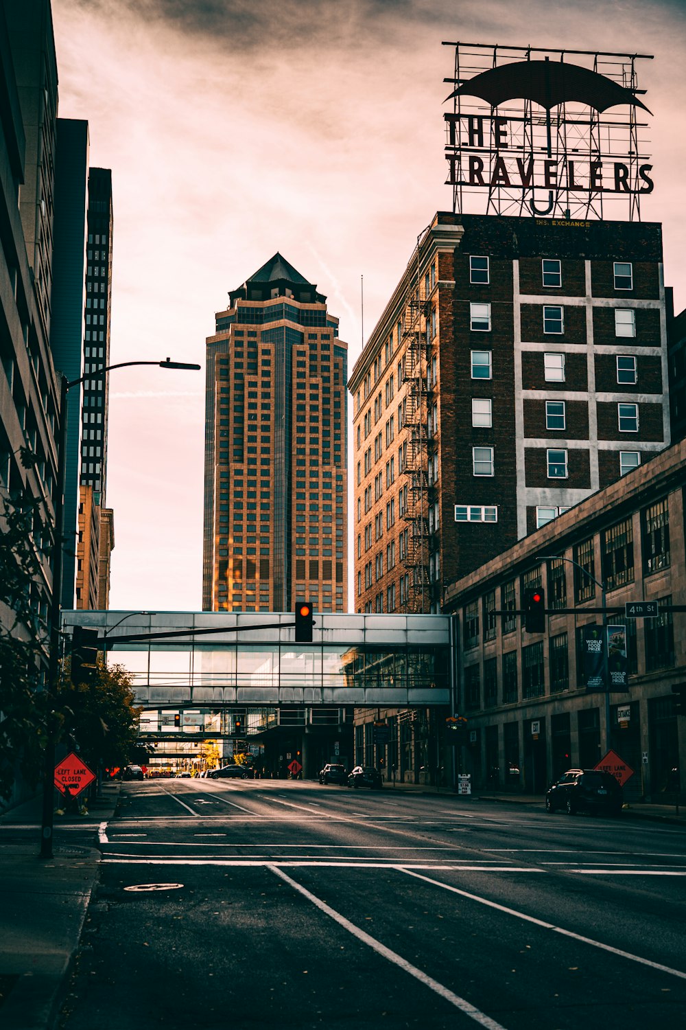 a city street with tall buildings and a traffic light