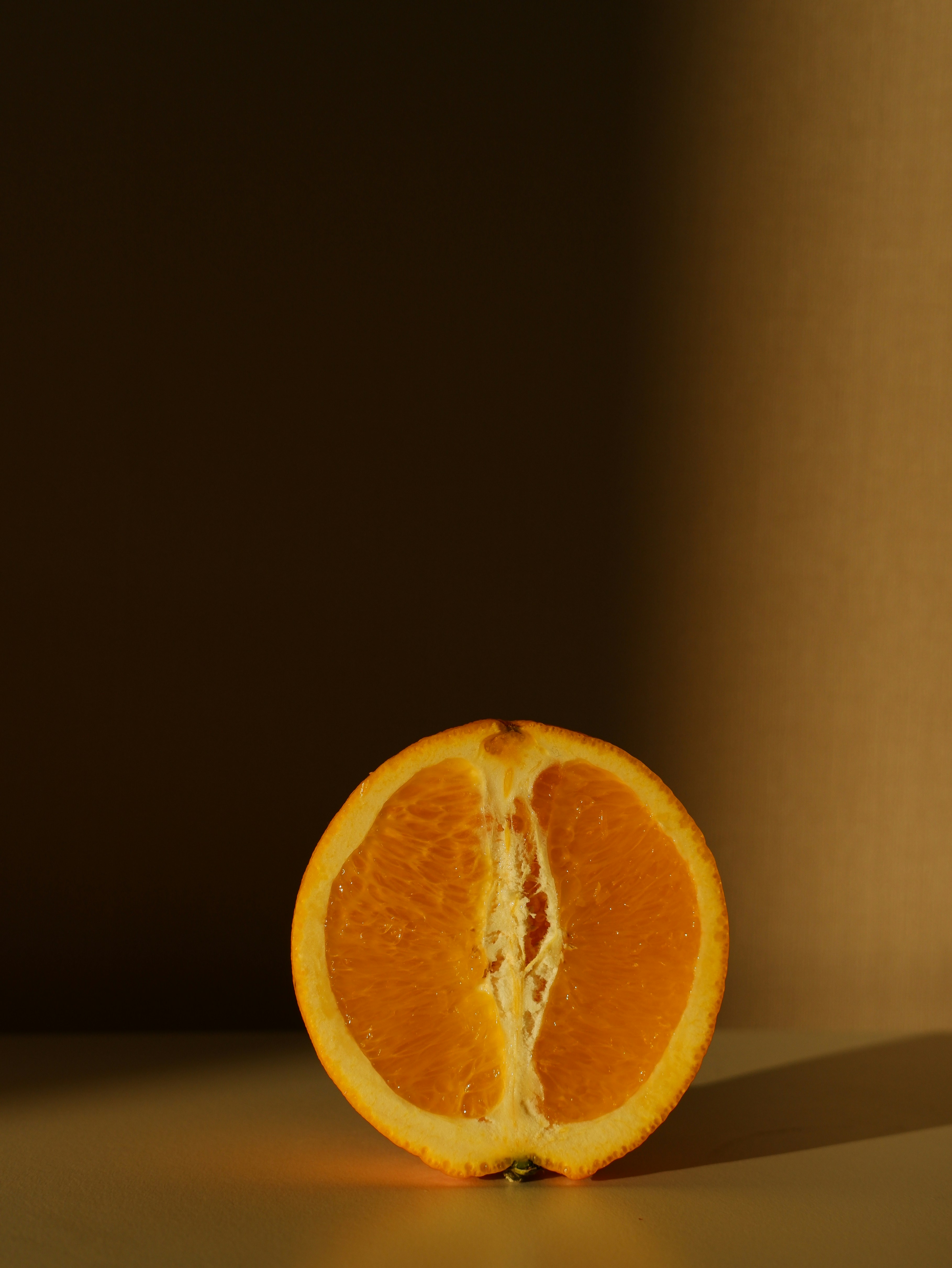 an orange cut in half sitting on a table