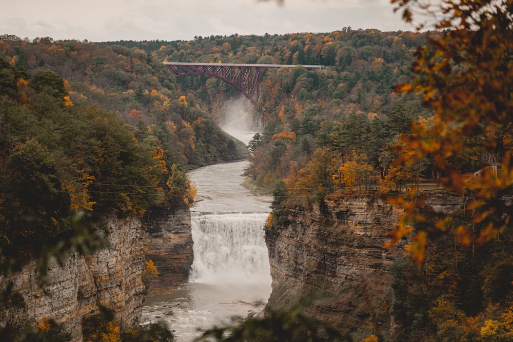 a bridge over a river with a waterfall below