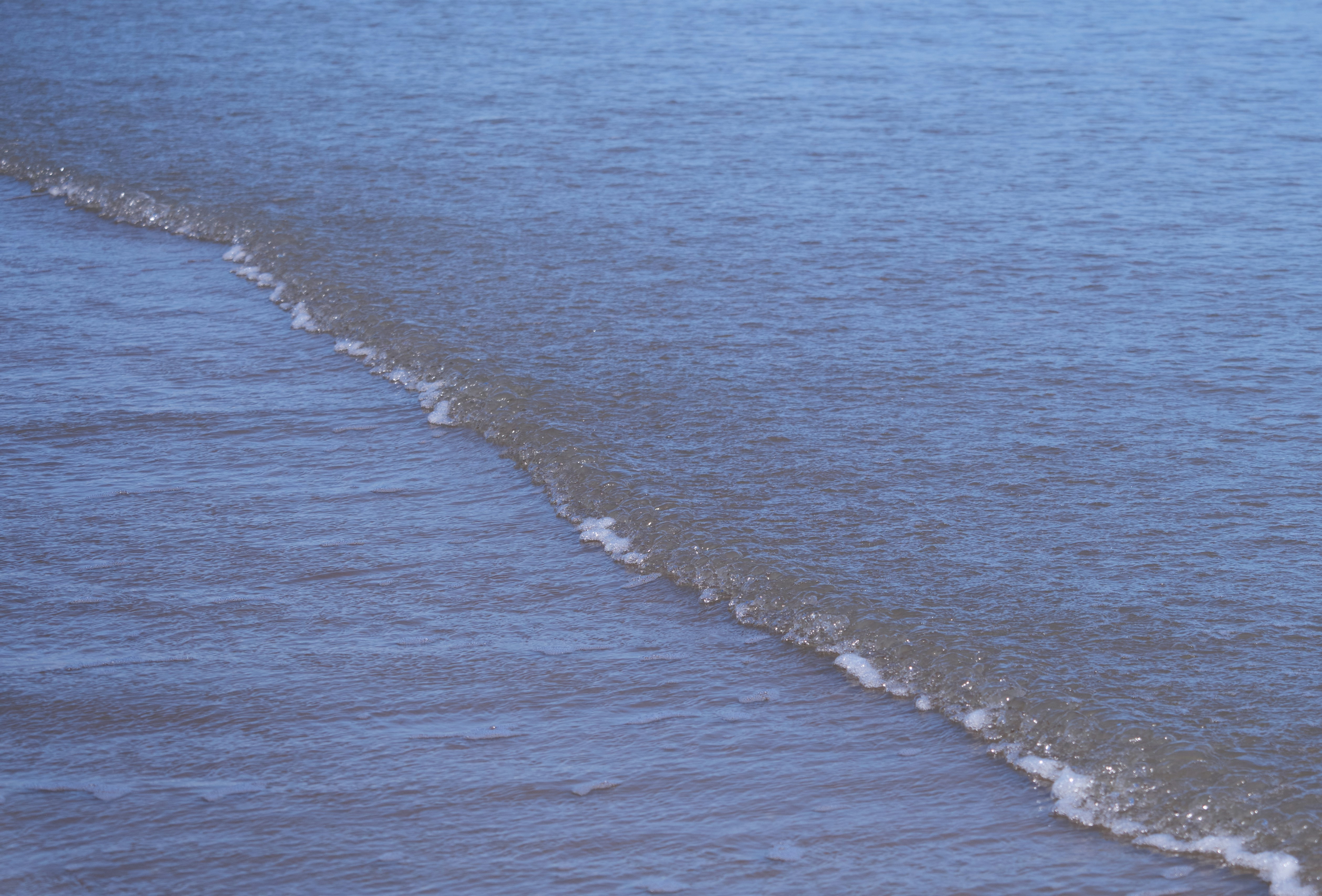 a man riding a surfboard on top of a wave in the ocean