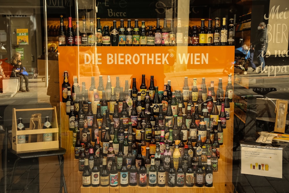 a display of beer bottles in a store window