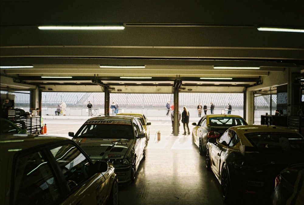 a group of cars parked inside of a garage