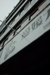 A modern Osaka high-rise apartment building with a welcoming entrance, symbolizing comfortable living for international residents.