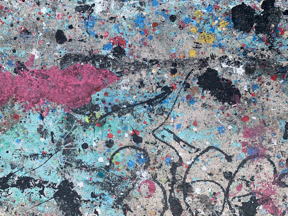 a close up of a wall with paint splattered on it