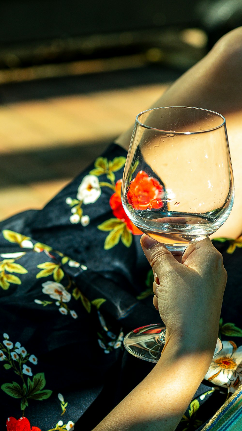 a woman holding a wine glass in her hand