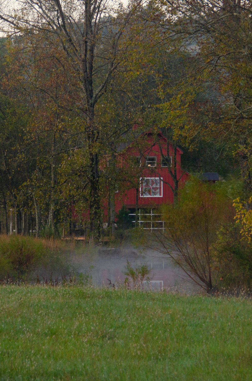 a red barn in the middle of a field