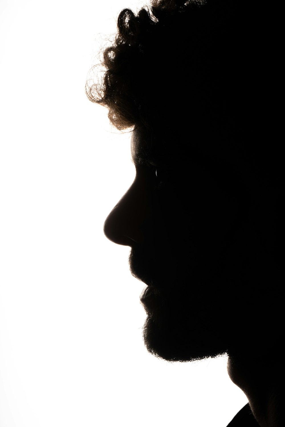 a silhouette of a man with a beard