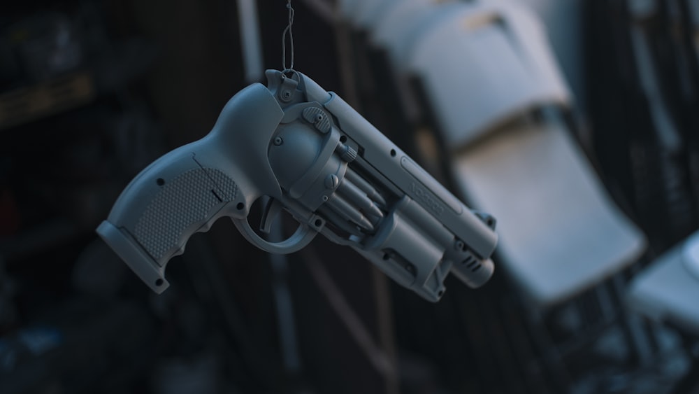 a toy gun hanging from a string in a room