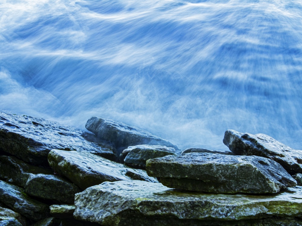 a bunch of rocks that are by some water