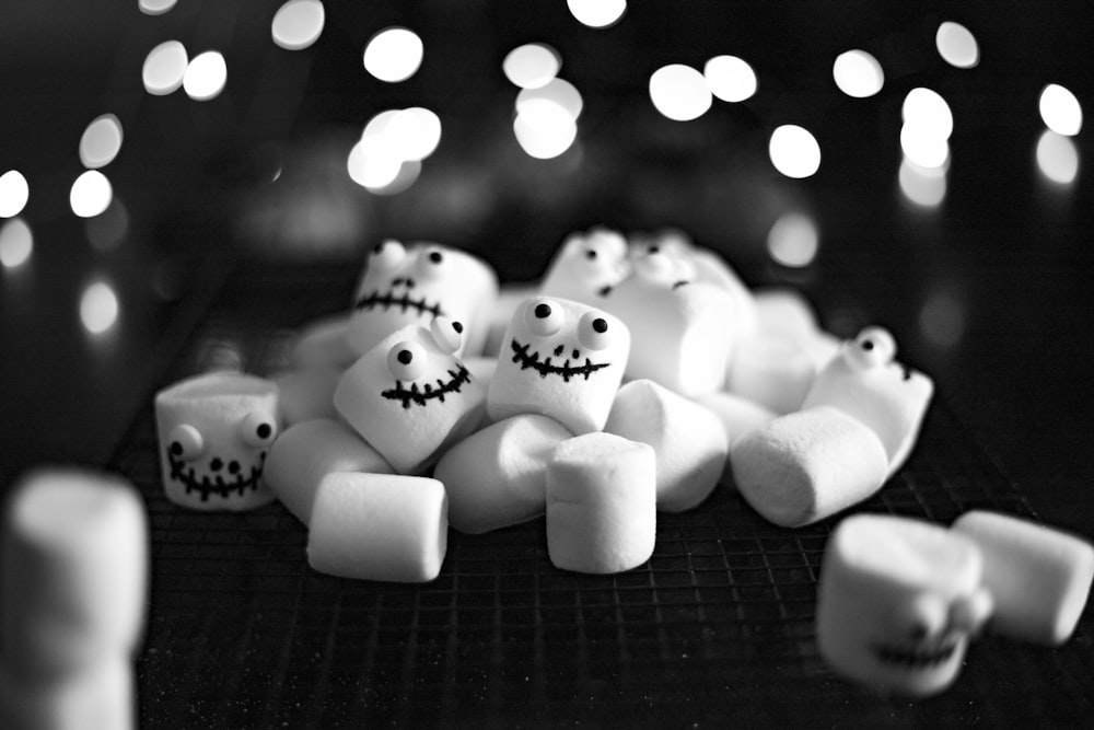 a black and white photo of marshmallows with faces