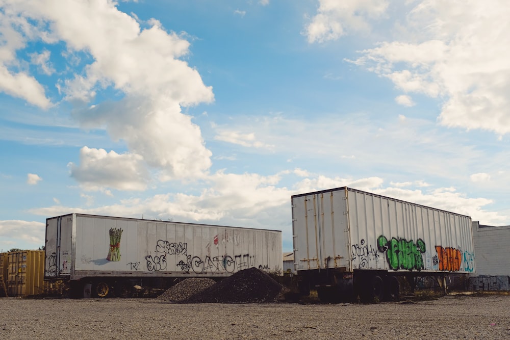 a couple of trucks that are sitting in the dirt