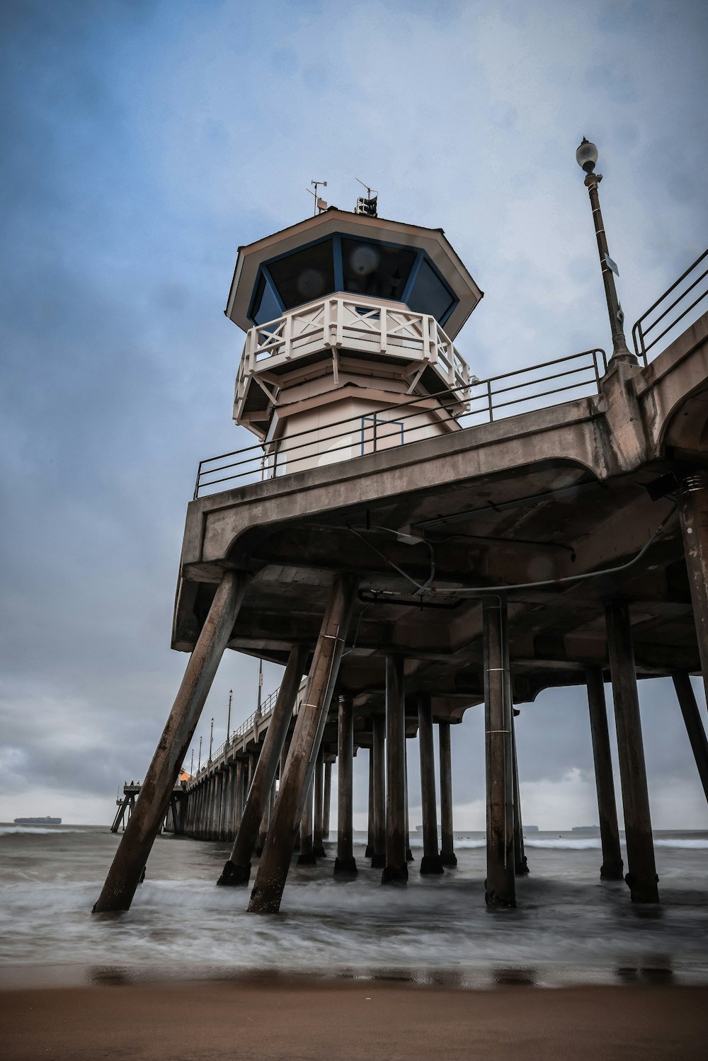 a wooden pier with a light house on top of it