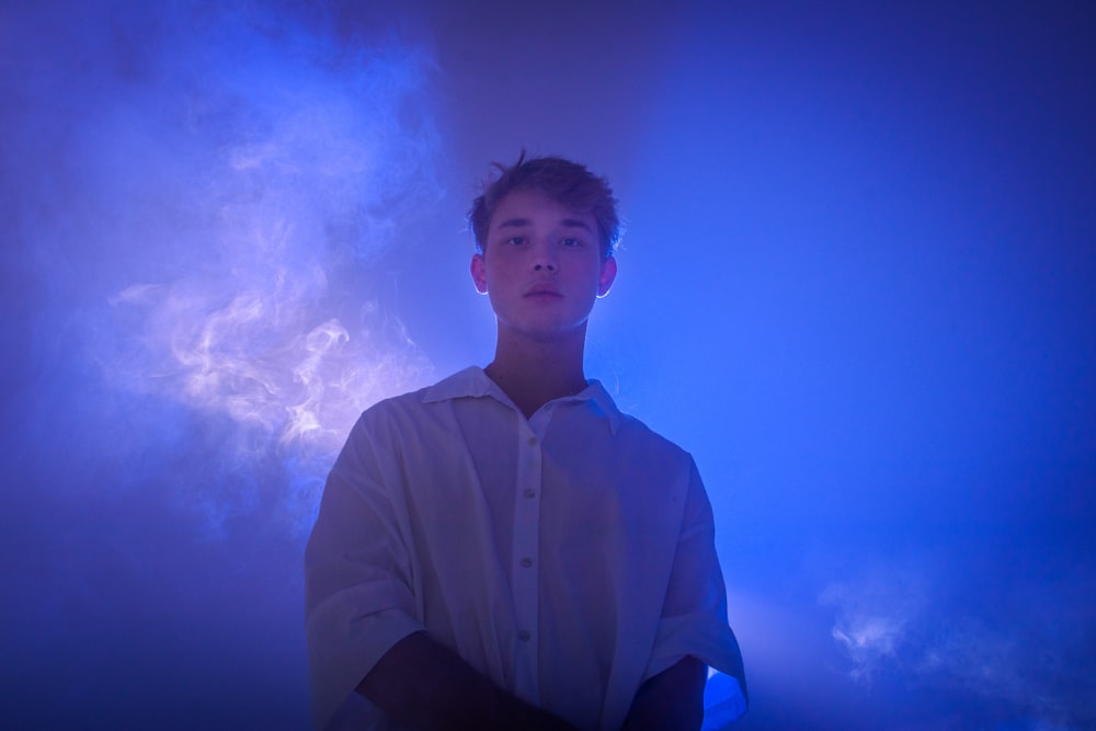 A man standing in front of a blue light photo – Free Light Image on Unsplash