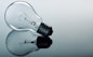 a light bulb sitting on top of a reflective surface