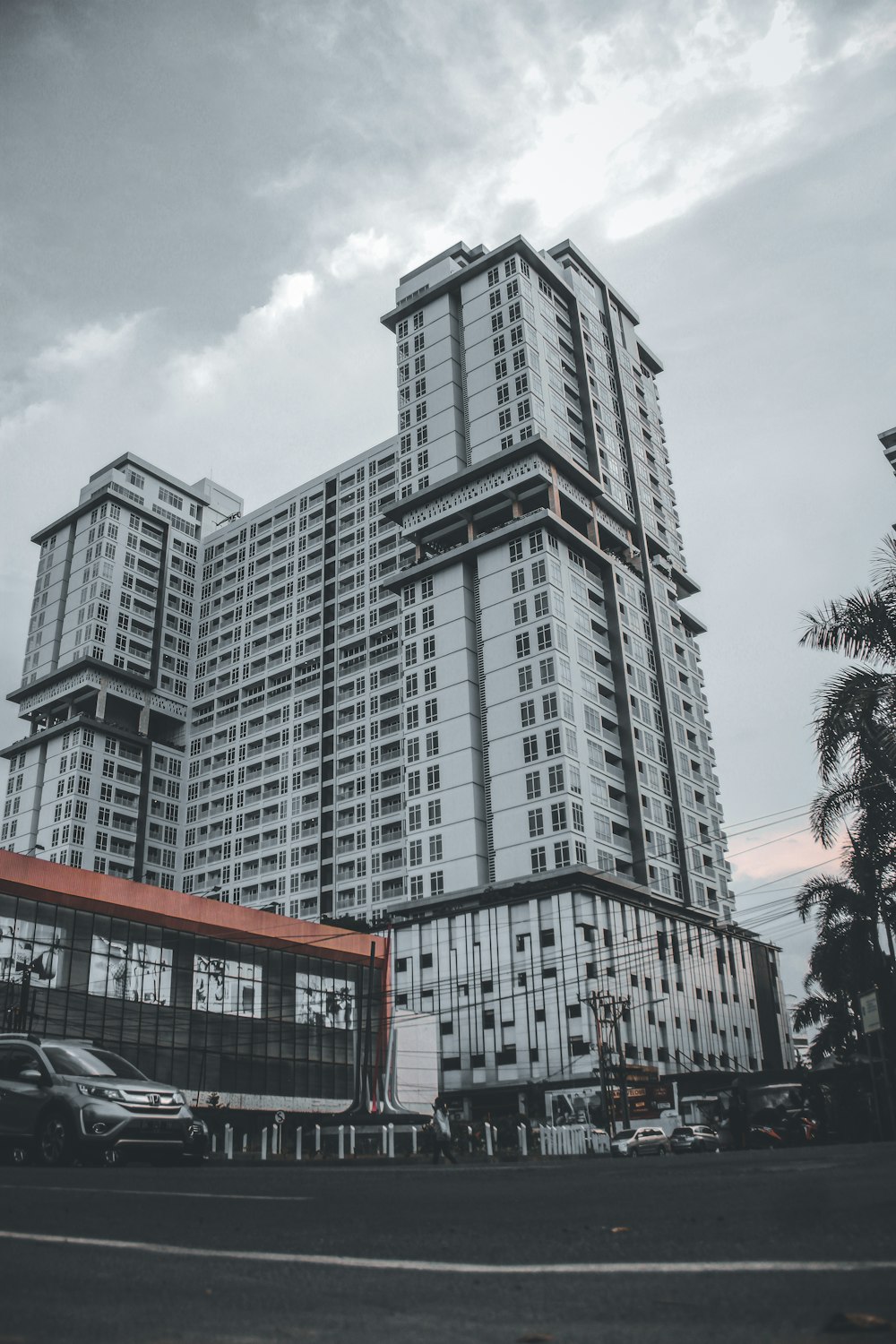 a very tall building sitting next to a parking lot