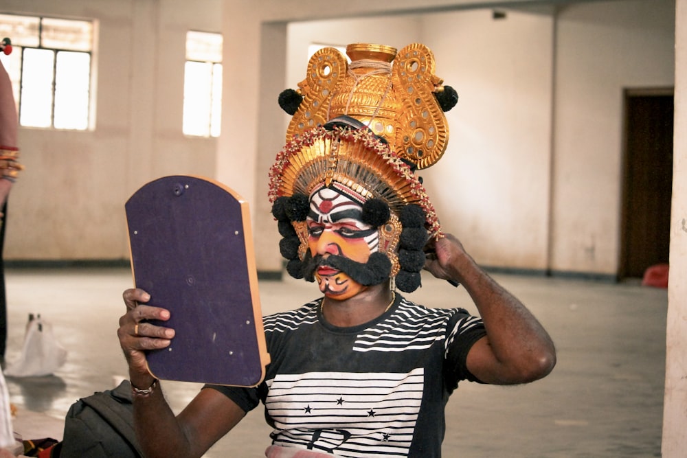 a man with a mask holding a skateboard