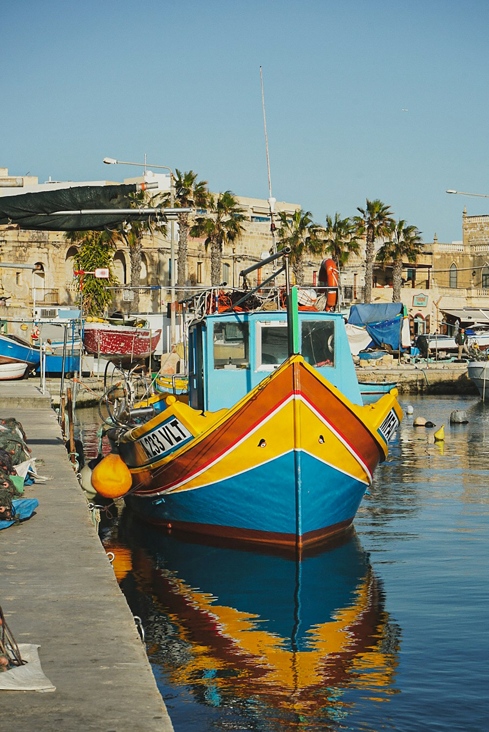 a colorful boat is docked at a dock