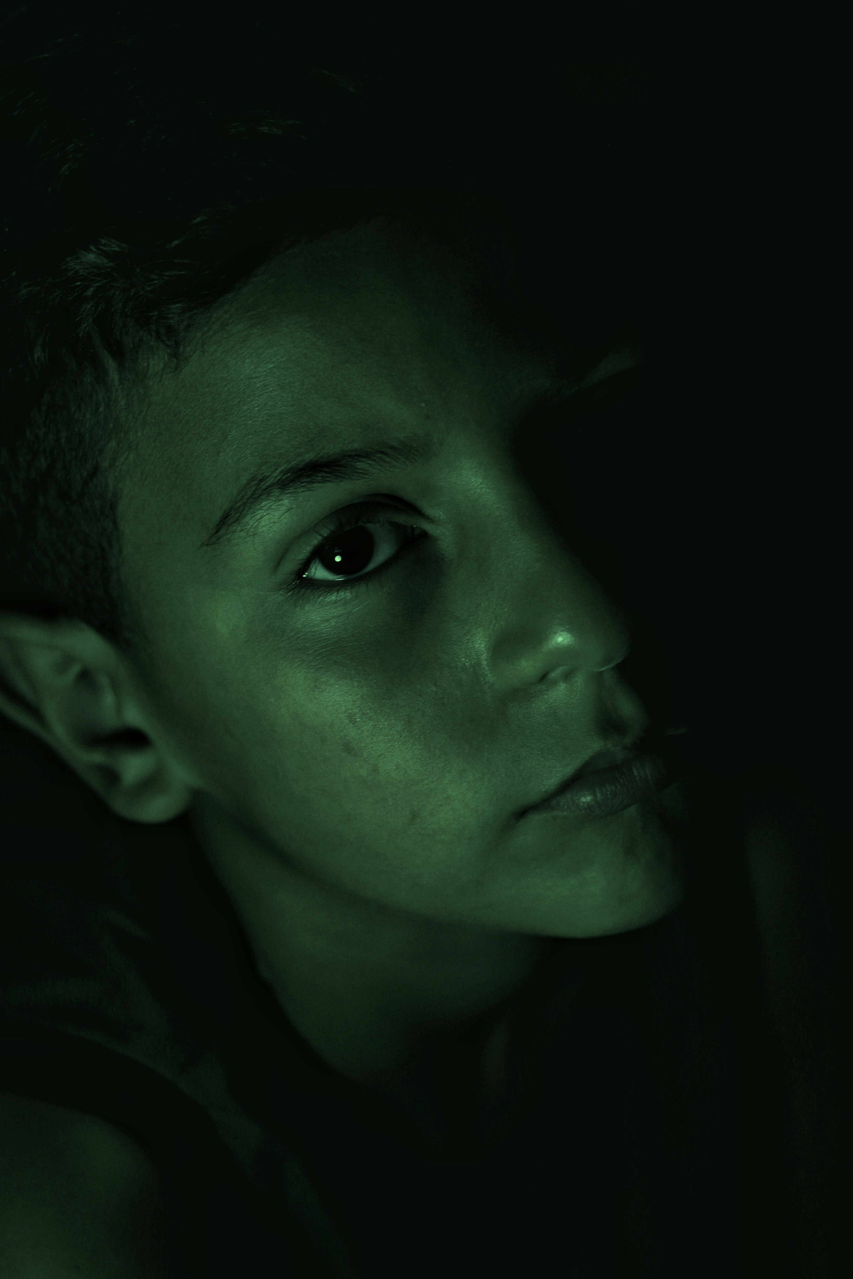 a young boy is staring into the distance