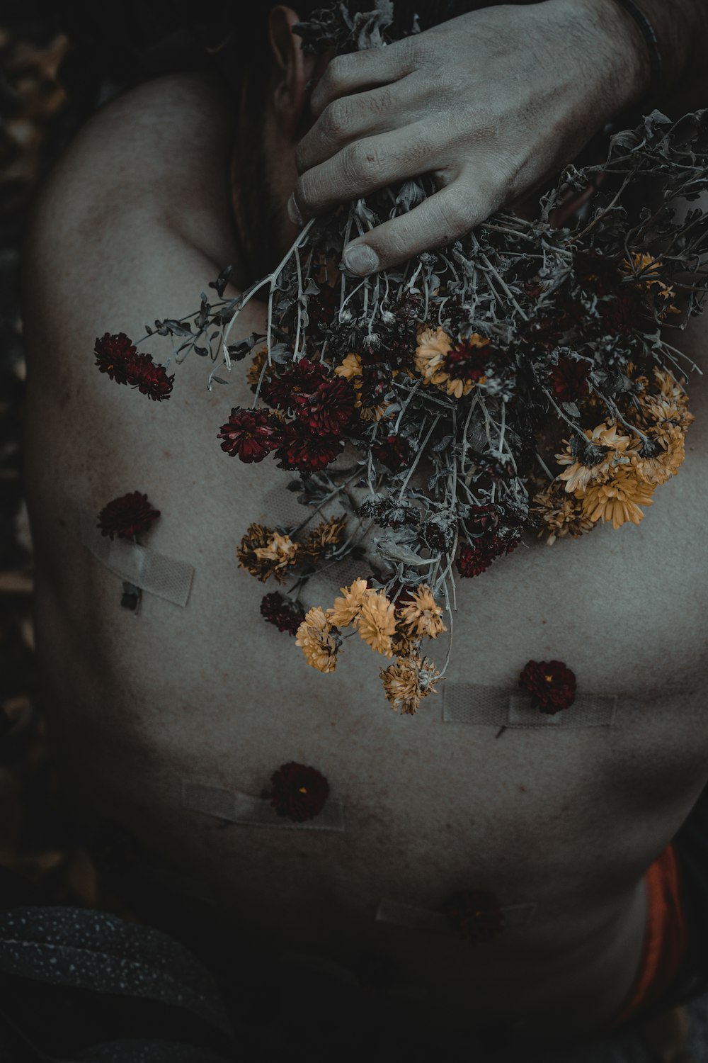 a person holding a bunch of flowers in their stomach