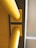 Two large yellow pipes aligned horizontally against a structural wall, with clear geometric shapes and sharp angles in the background.