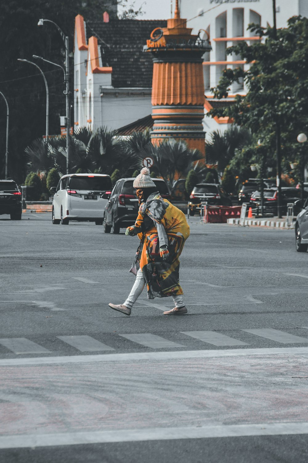 a person crossing a street in a city