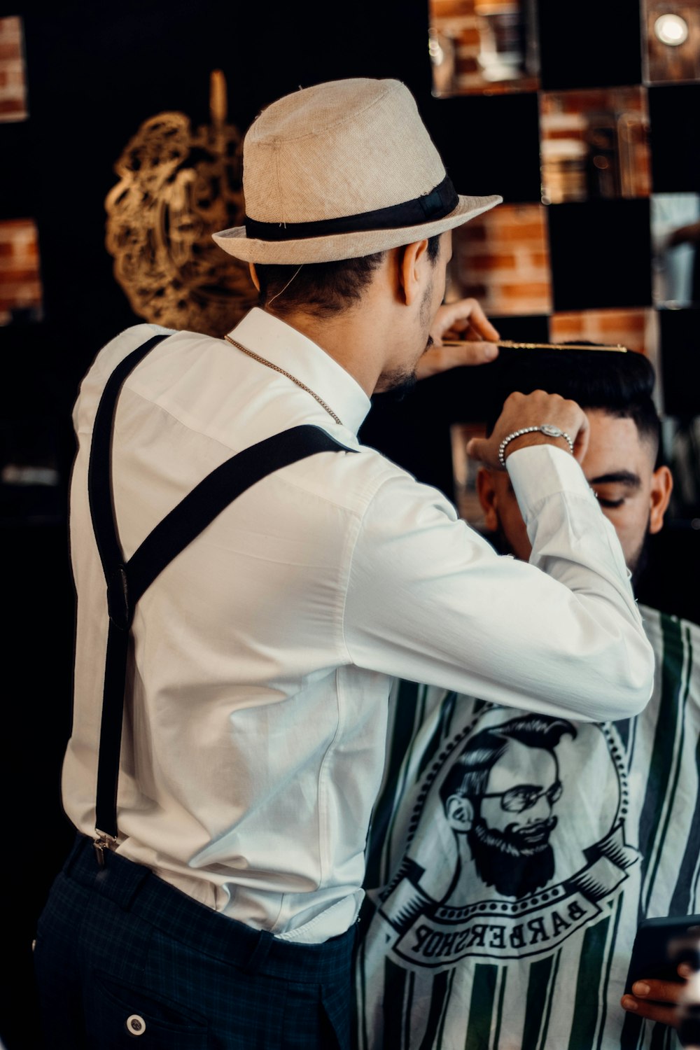 a man with a hat and suspenders is brushing his teeth