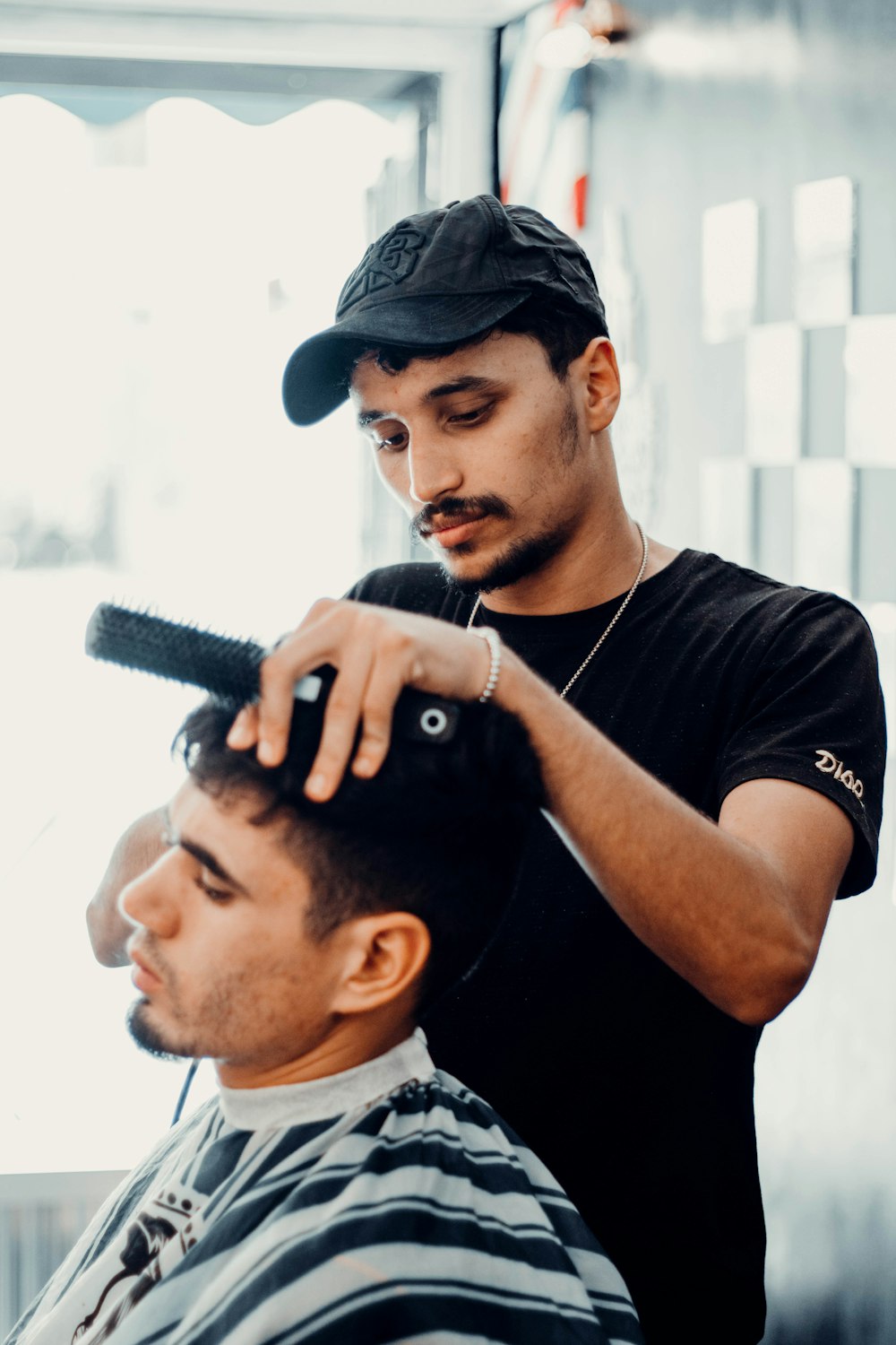 a man cutting another mans hair in a barber shop