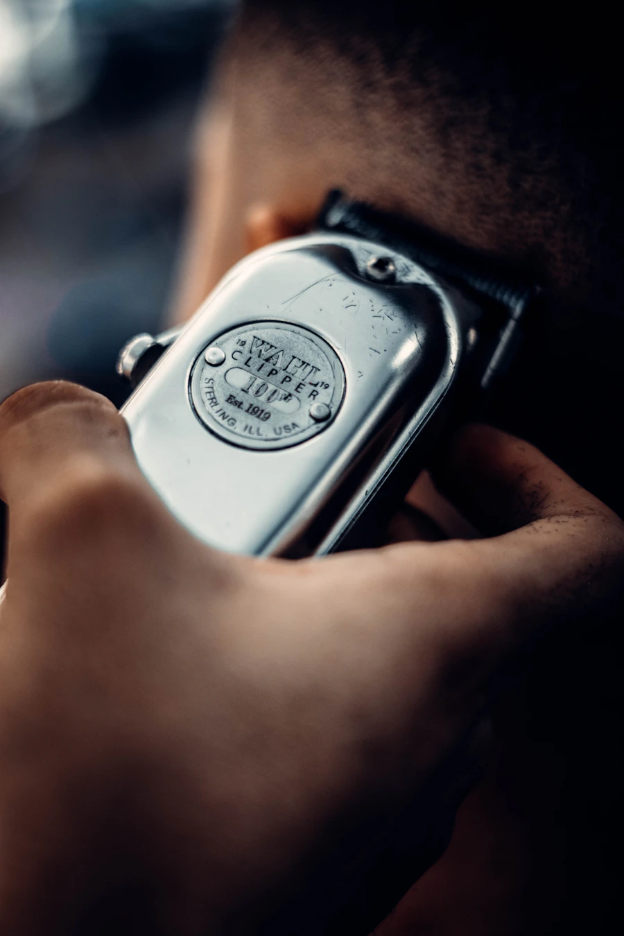 A clipper detail against dark clothing