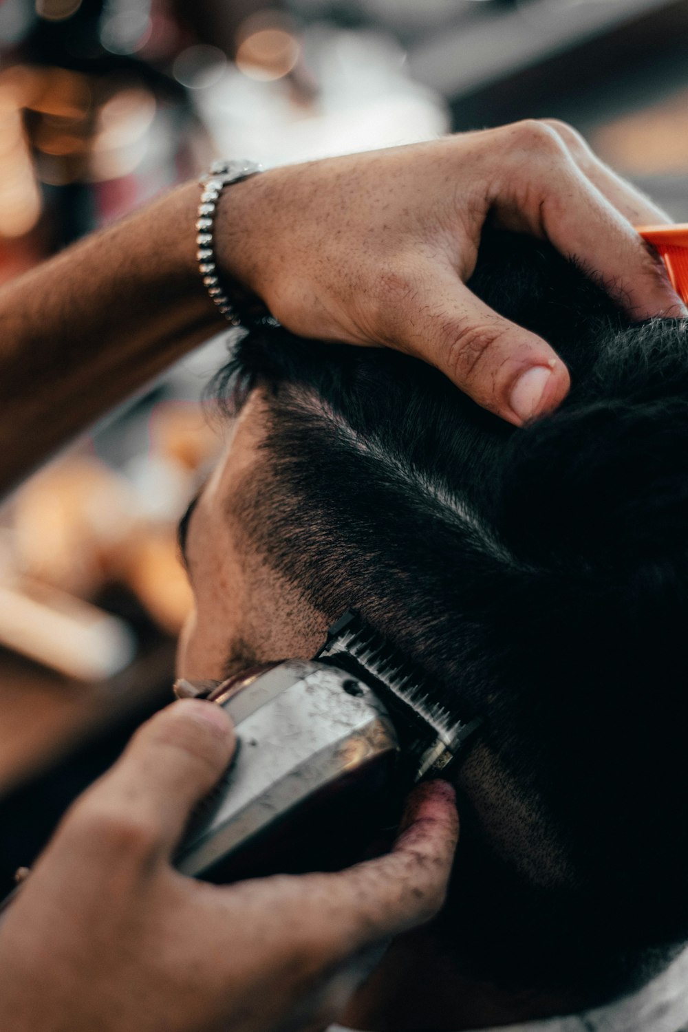a close up of a person cutting another persons hair