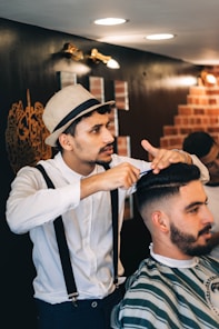 a man getting his hair cut by a barber