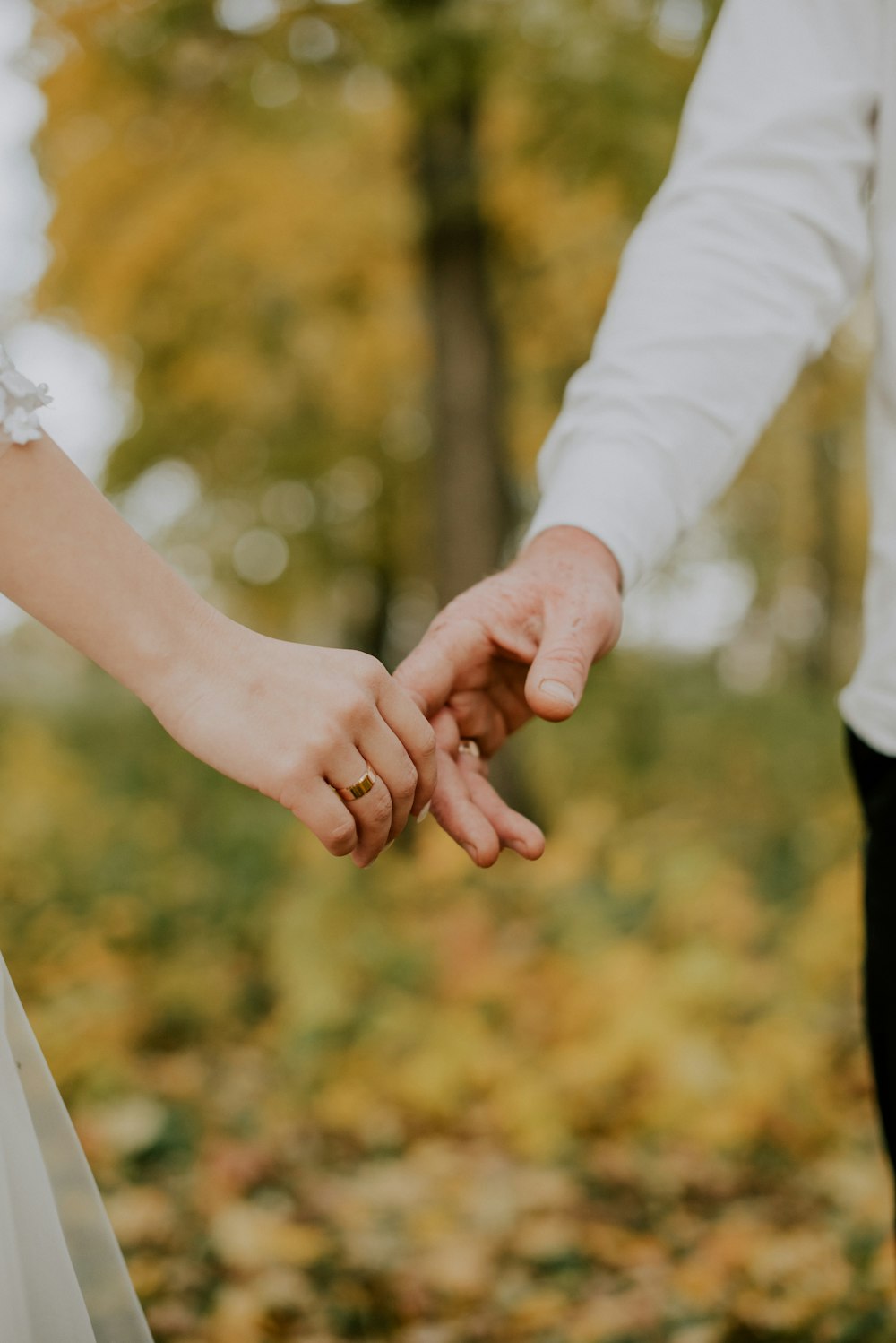 a close up of a person holding the hand of a person