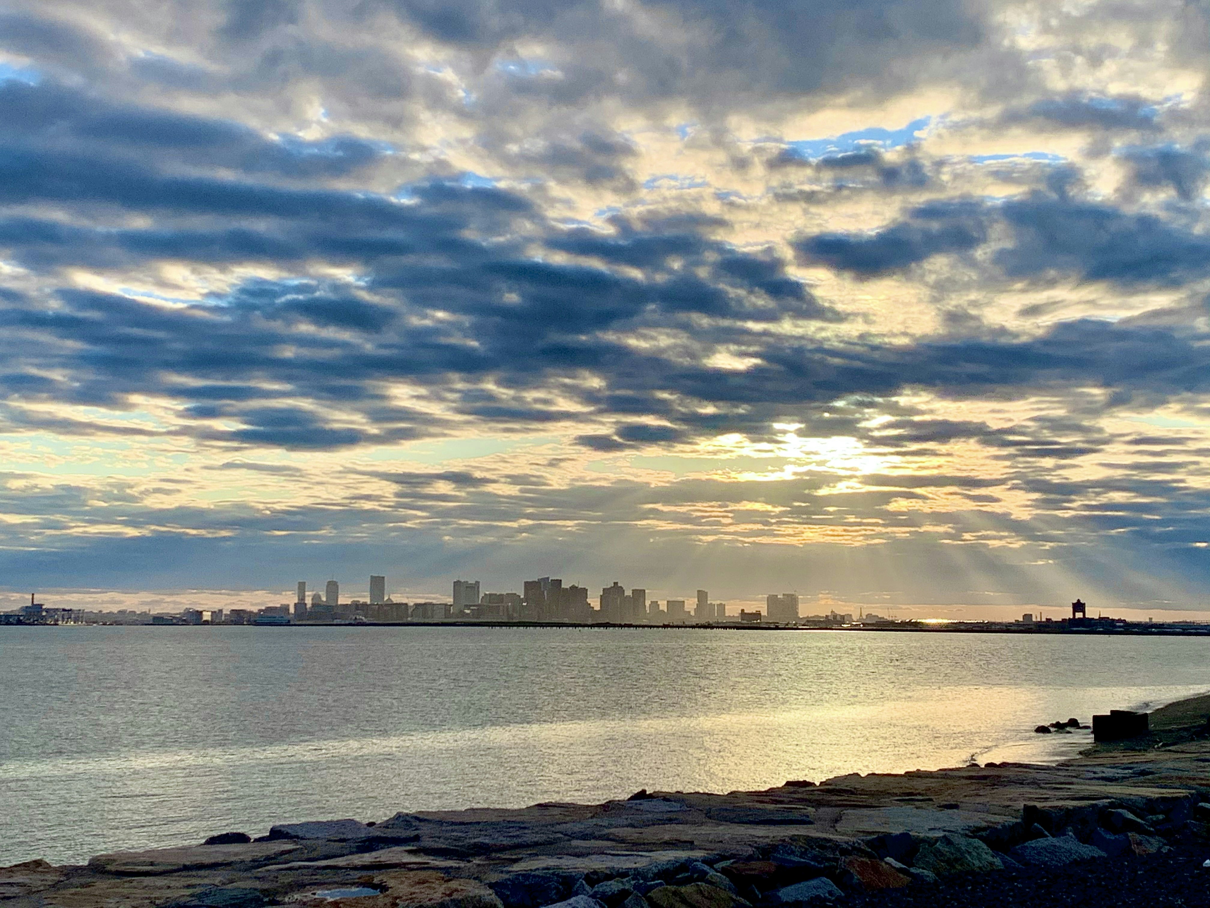 a body of water with a city in the background