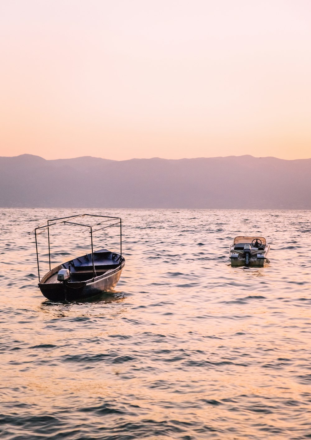 a couple of boats floating on top of a body of water