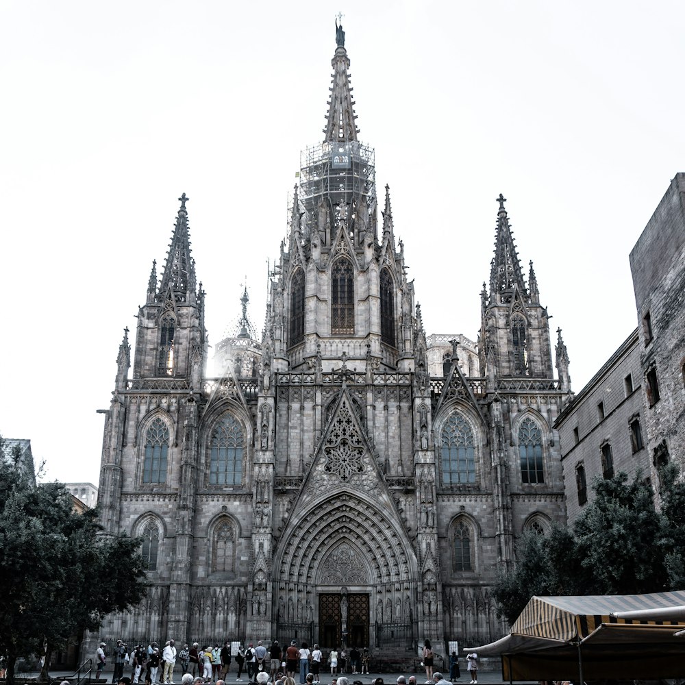 a group of people standing in front of a large cathedral