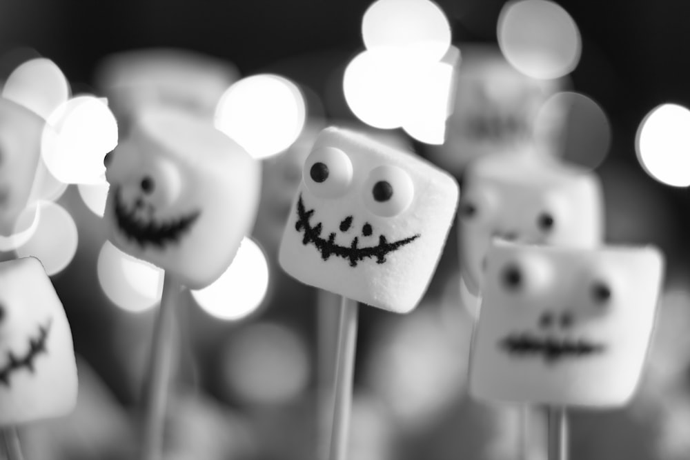 a group of marshmallows with faces painted on them