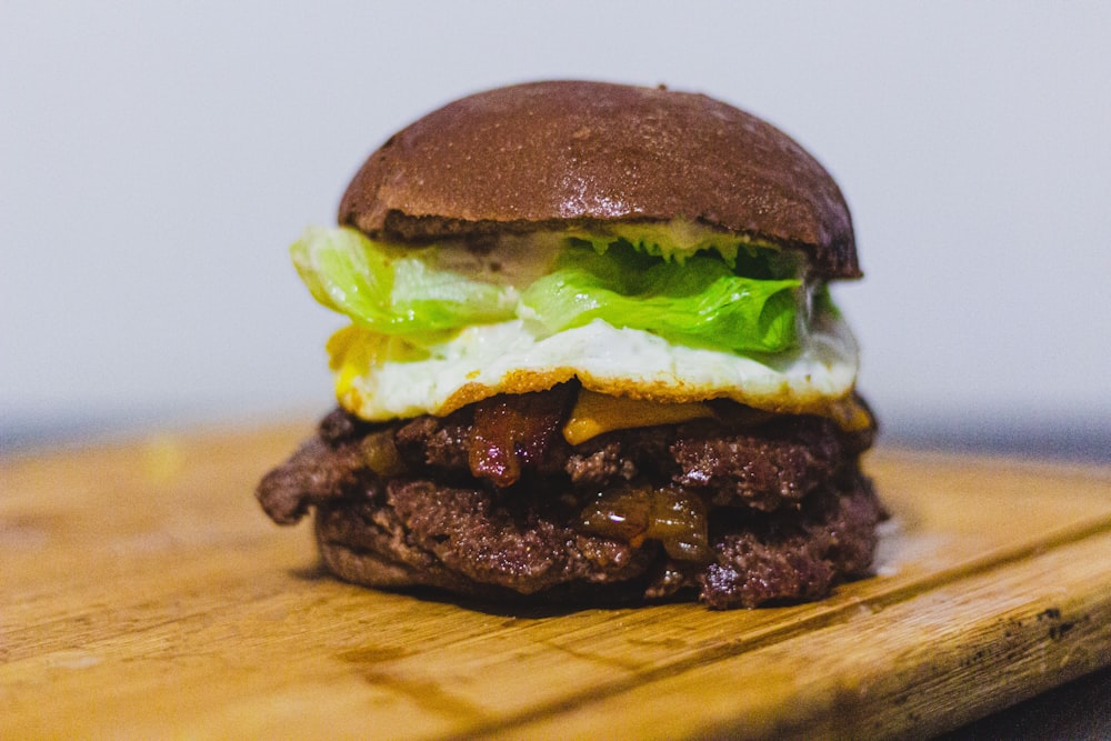 a close up of a hamburger on a cutting board
