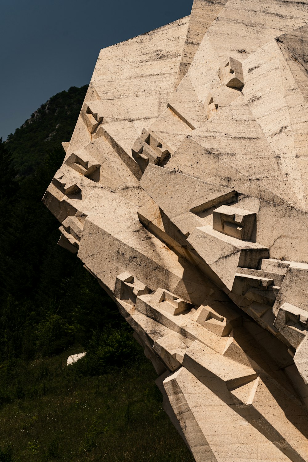 a large rock formation with a sky background