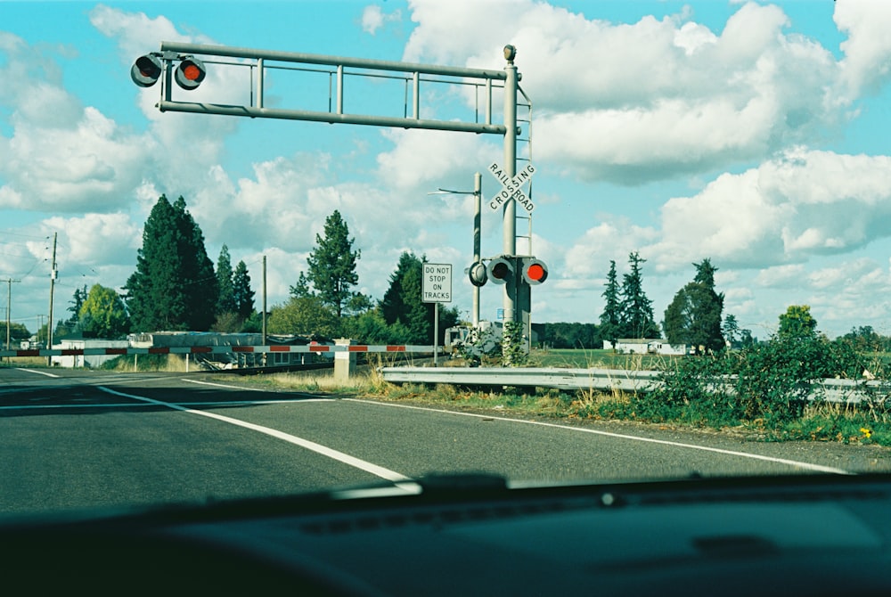 a red traffic light hanging over a road