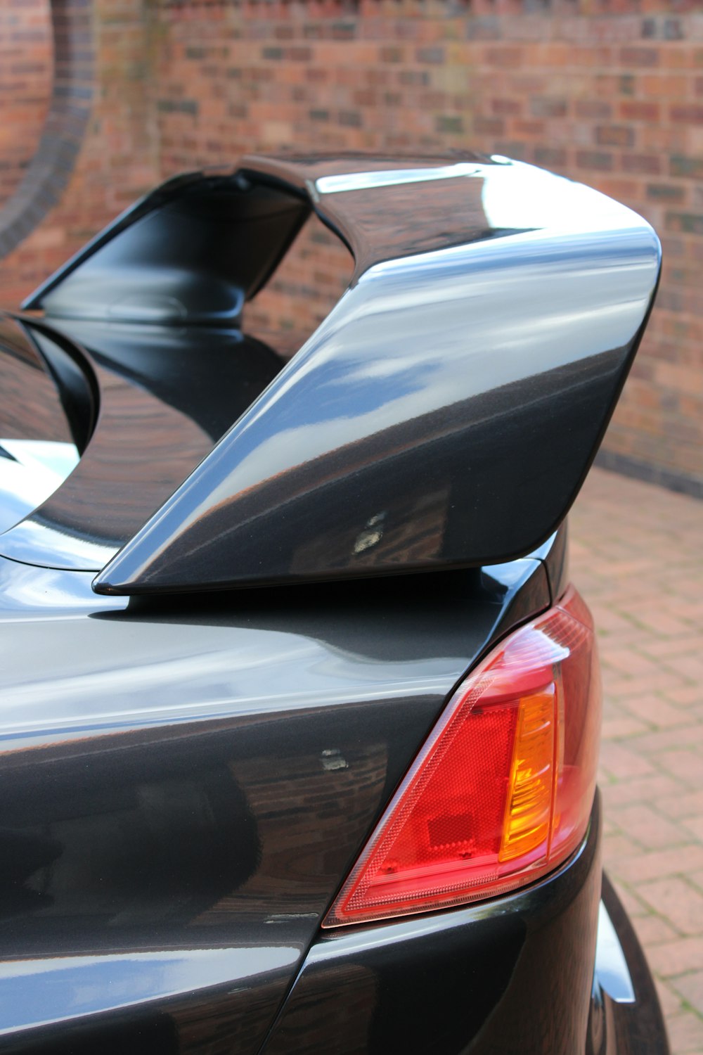 the back end of a black car with its door open