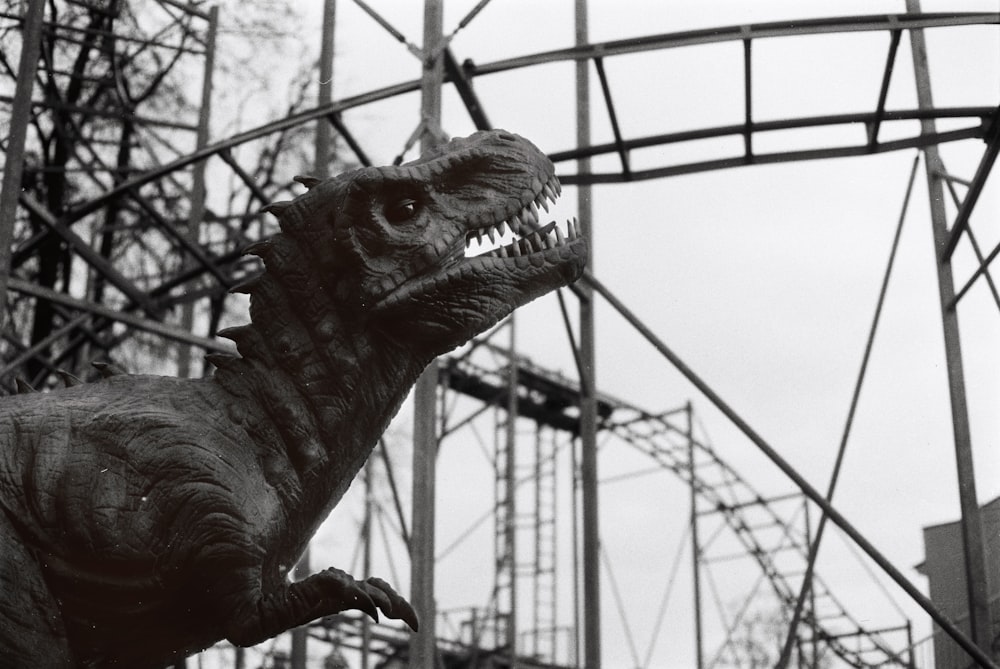 a black and white photo of a dinosaur statue