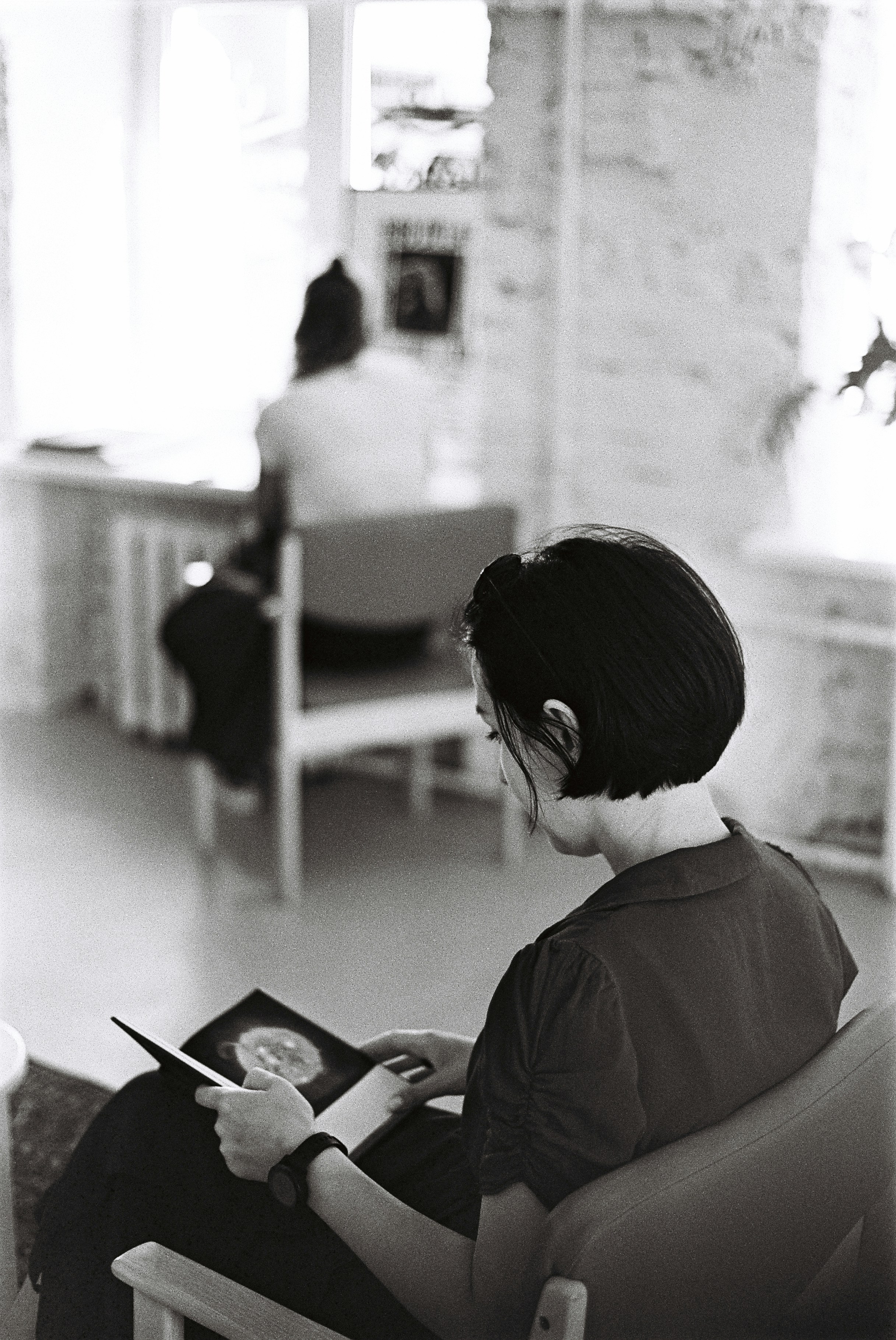 a woman sitting in a chair reading a book